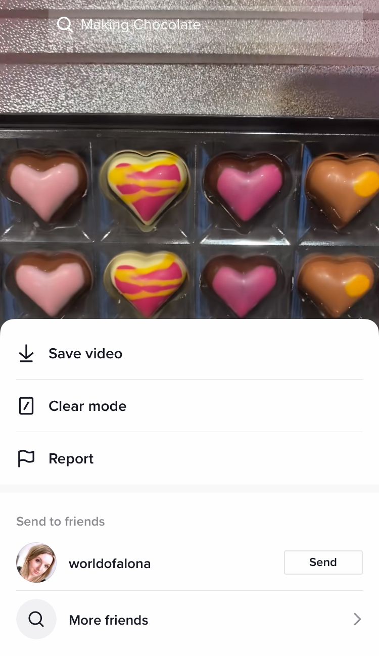 Press down on the middle of the screen while on a TikTok video to reveal the hidden menu
